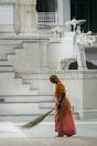 Jain sweeping the ground with brush
